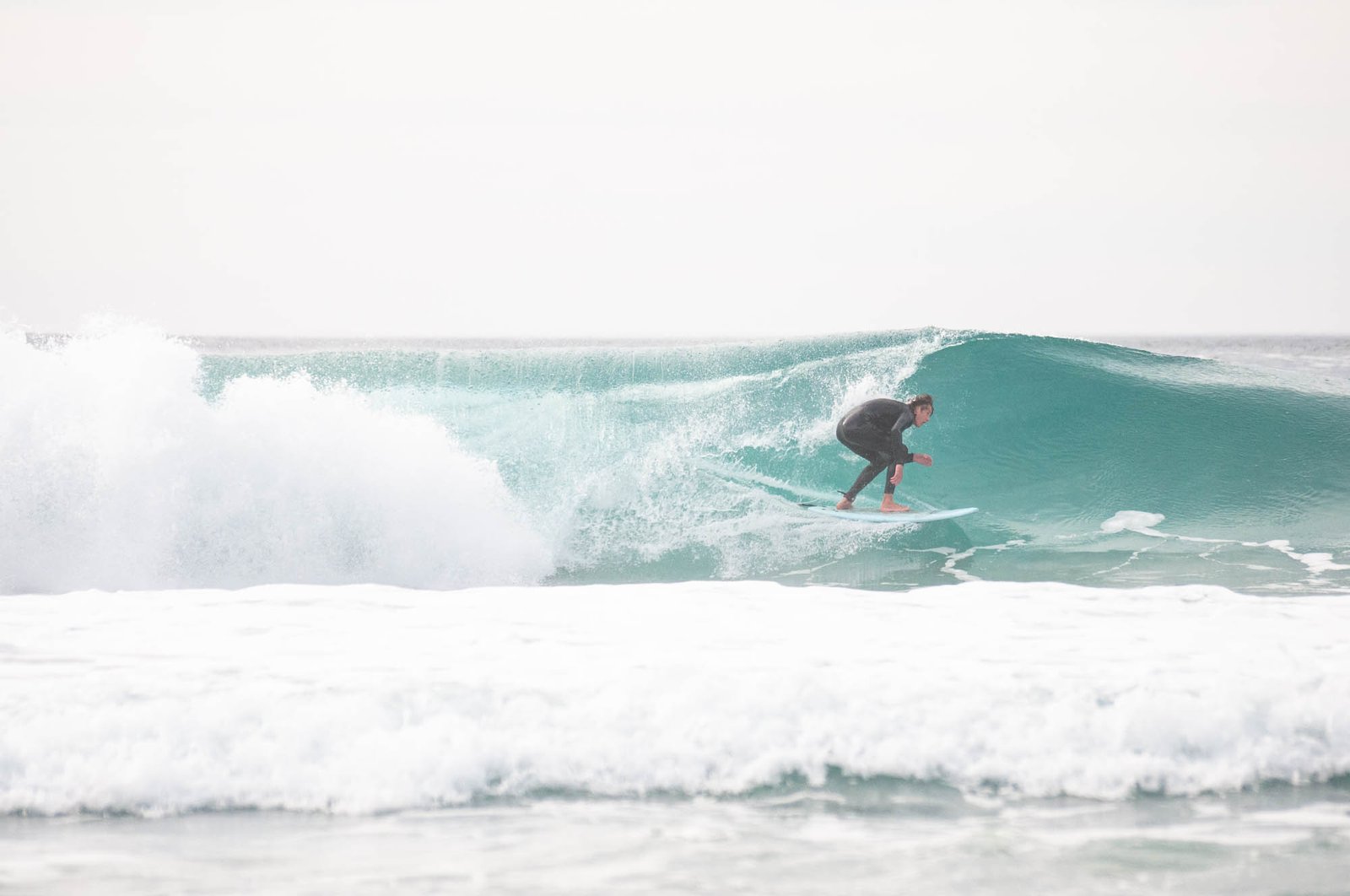 Surfer taking barrel wave in California